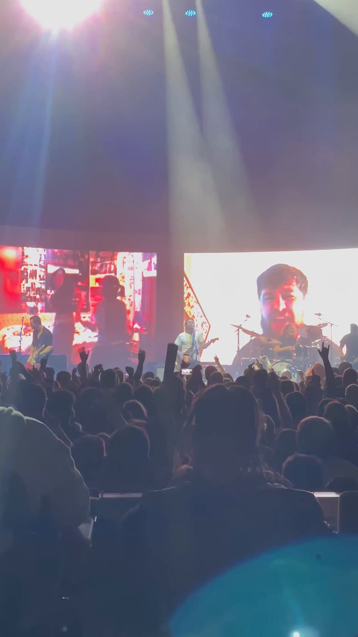 FOH over a clapping crowd, curved LED with colour IMAG and the Feeder logo, Comfort In Sound Tour 2025. Hover or tap to play.