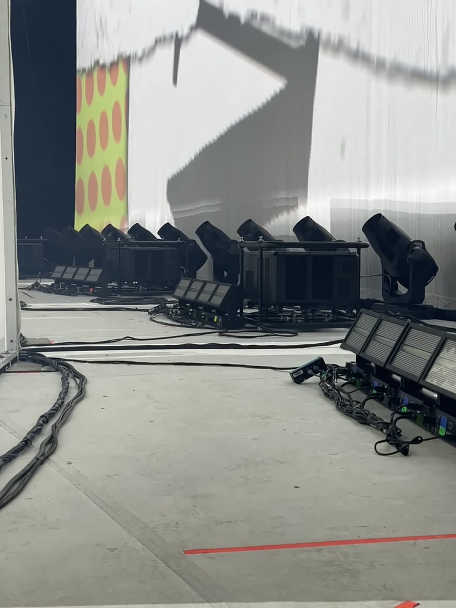 Touring projectors and LED strobes on the stage floor, aimed at a projection screen, Keane Hopes and Fears UK Arena Tour 2024.