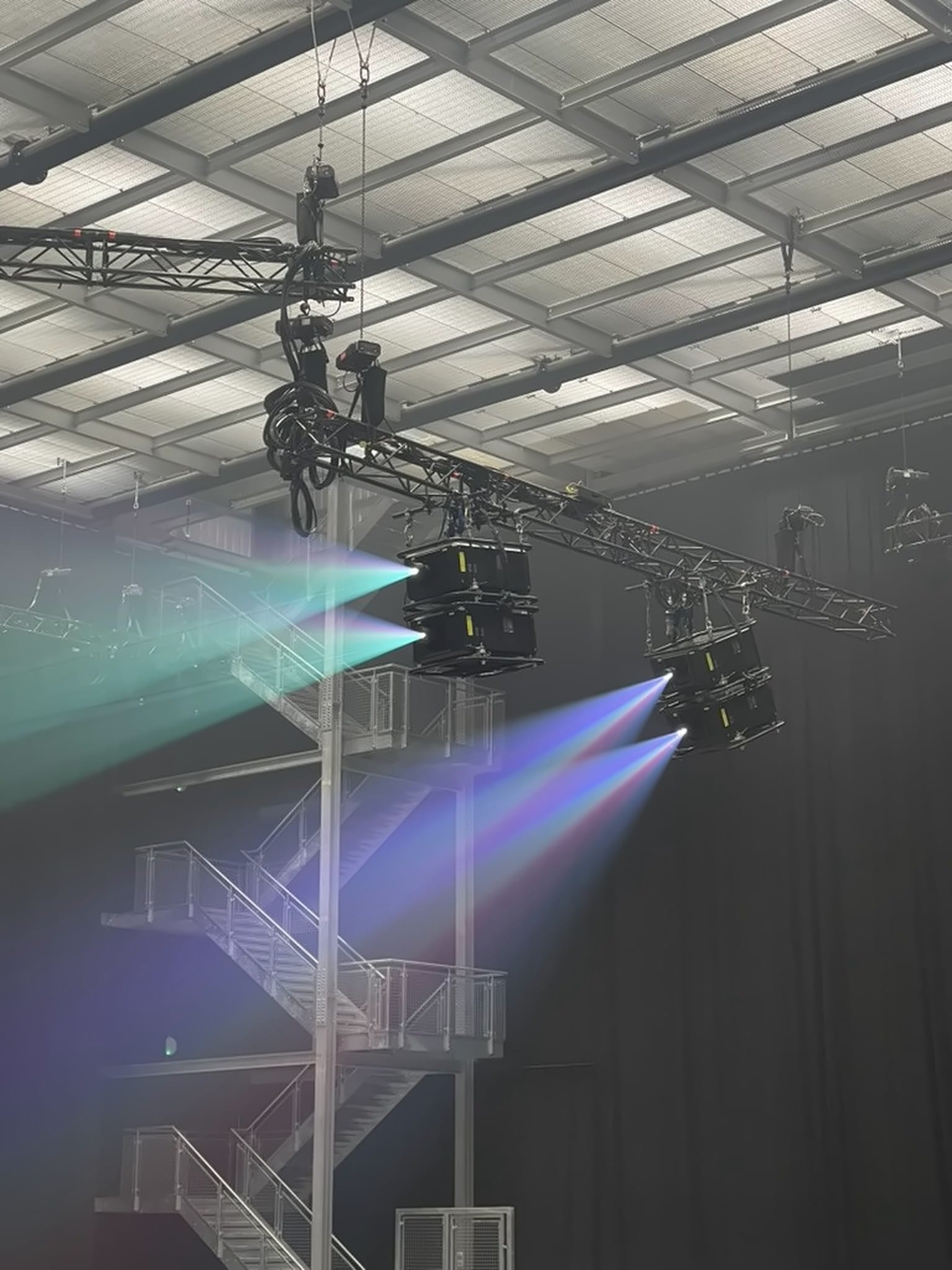 Stacked projectors on truss throwing colour beams, Keane Hopes and Fears UK Arena Tour 2024.
