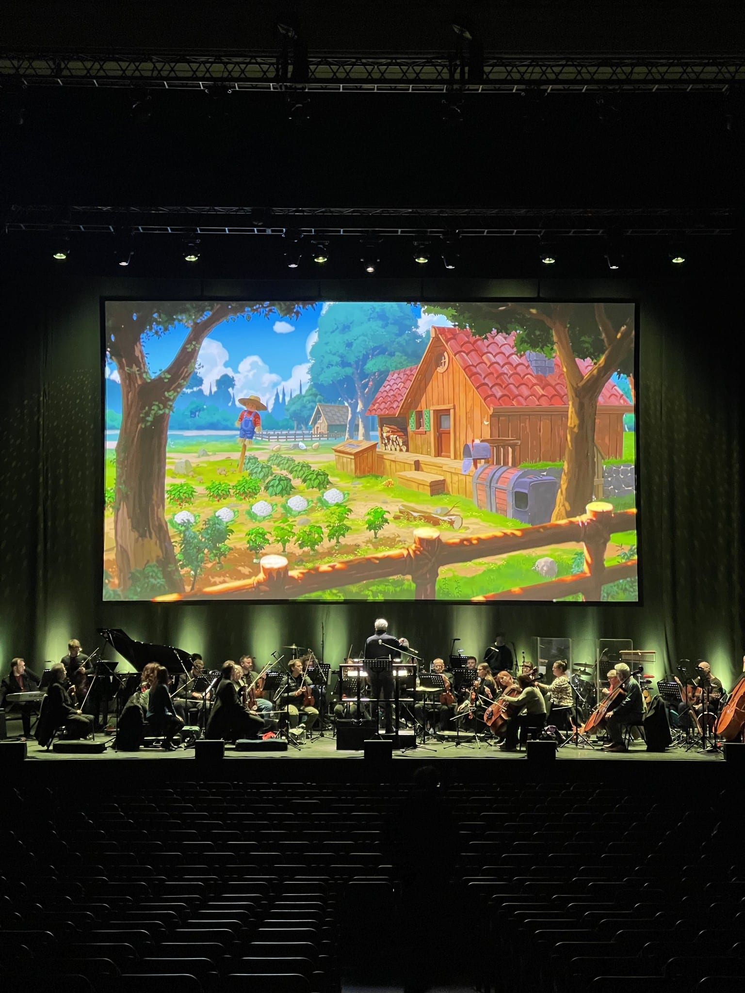 Orchestra under a farm scene on the main screen, Stardew Valley Symphony of Seasons UK tour, February 2026.